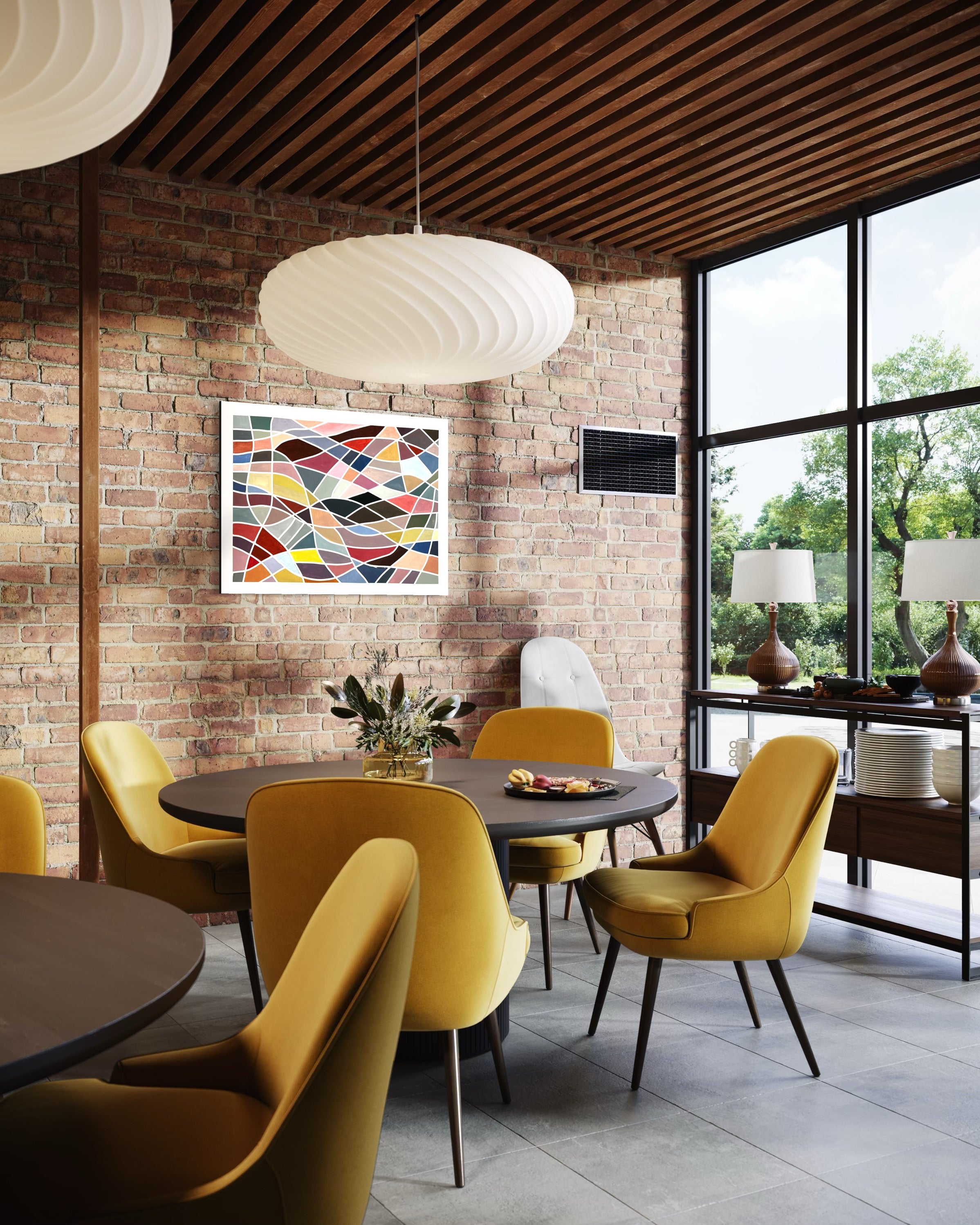 Modern dining area with yellow chairs, round tables, and a colorful geometric abstract painting ‘Color Grid Series III’ by Elena Alexander on a brick wall.