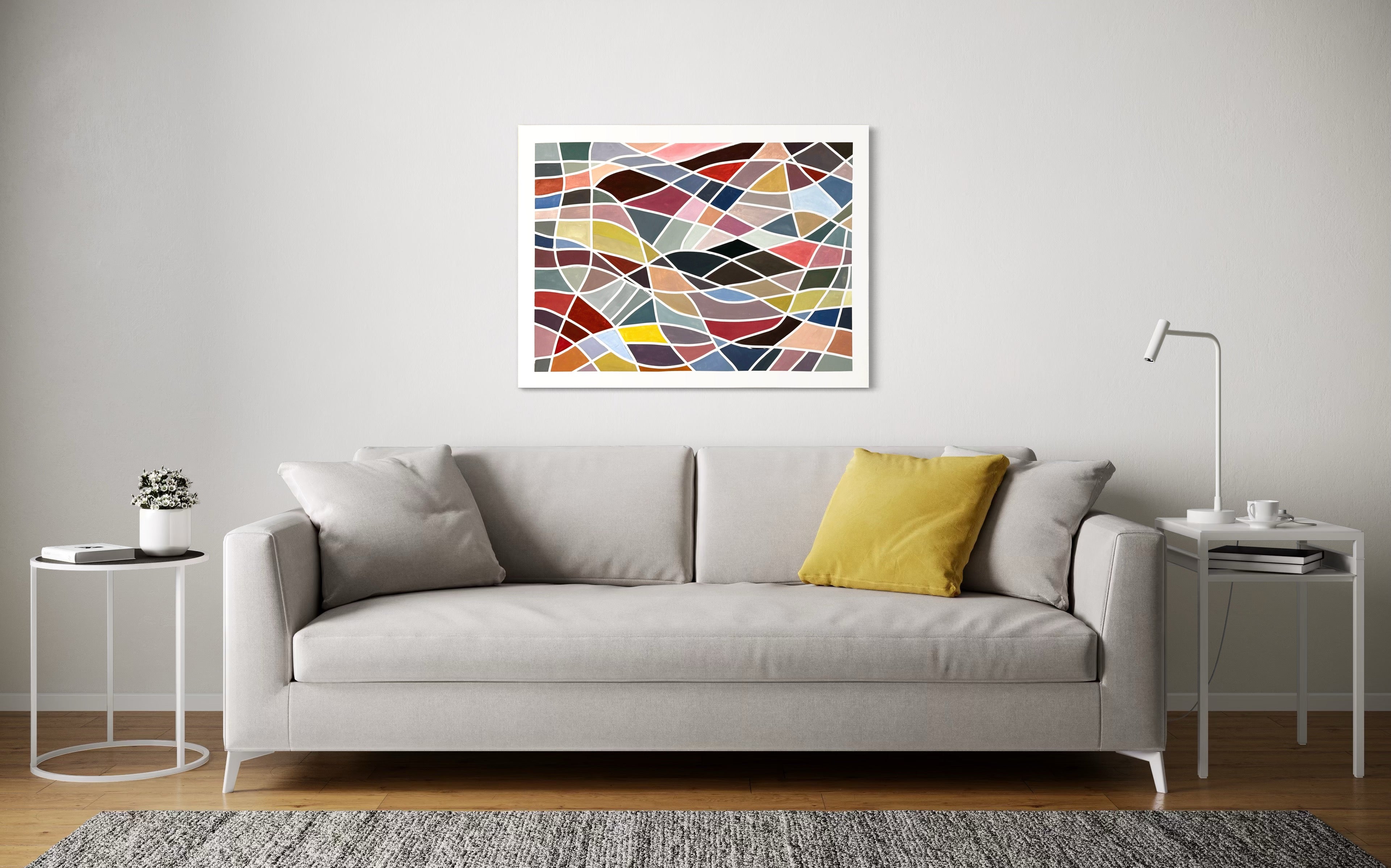 Gray sofa with a yellow pillow in a living room setting, featuring a colorful geometric abstract painting ‘Color Grid Series III’ by Elena Alexander on the wall.