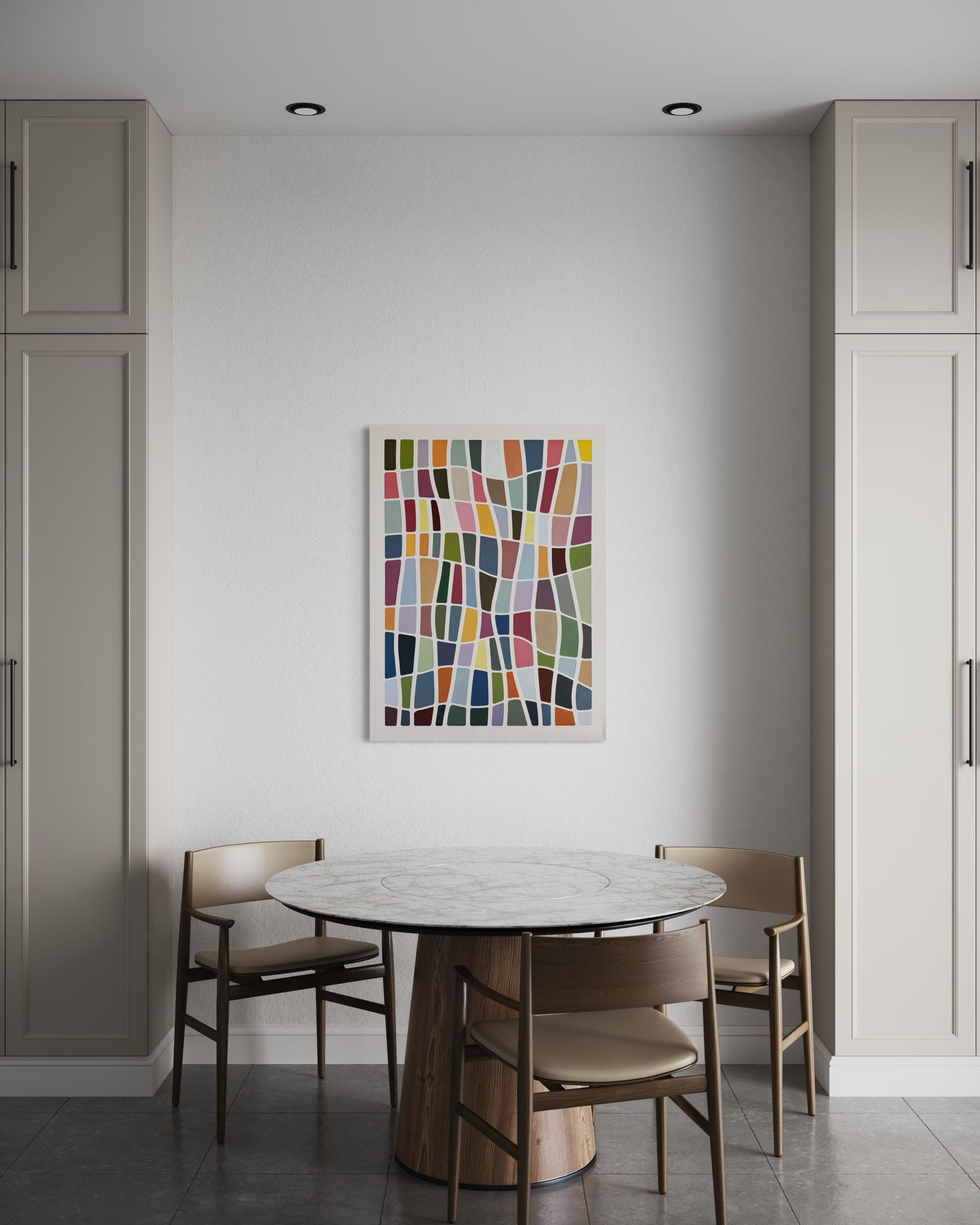 Dining area with a round table and chairs, featuring a colorful abstract painting on the wall.
