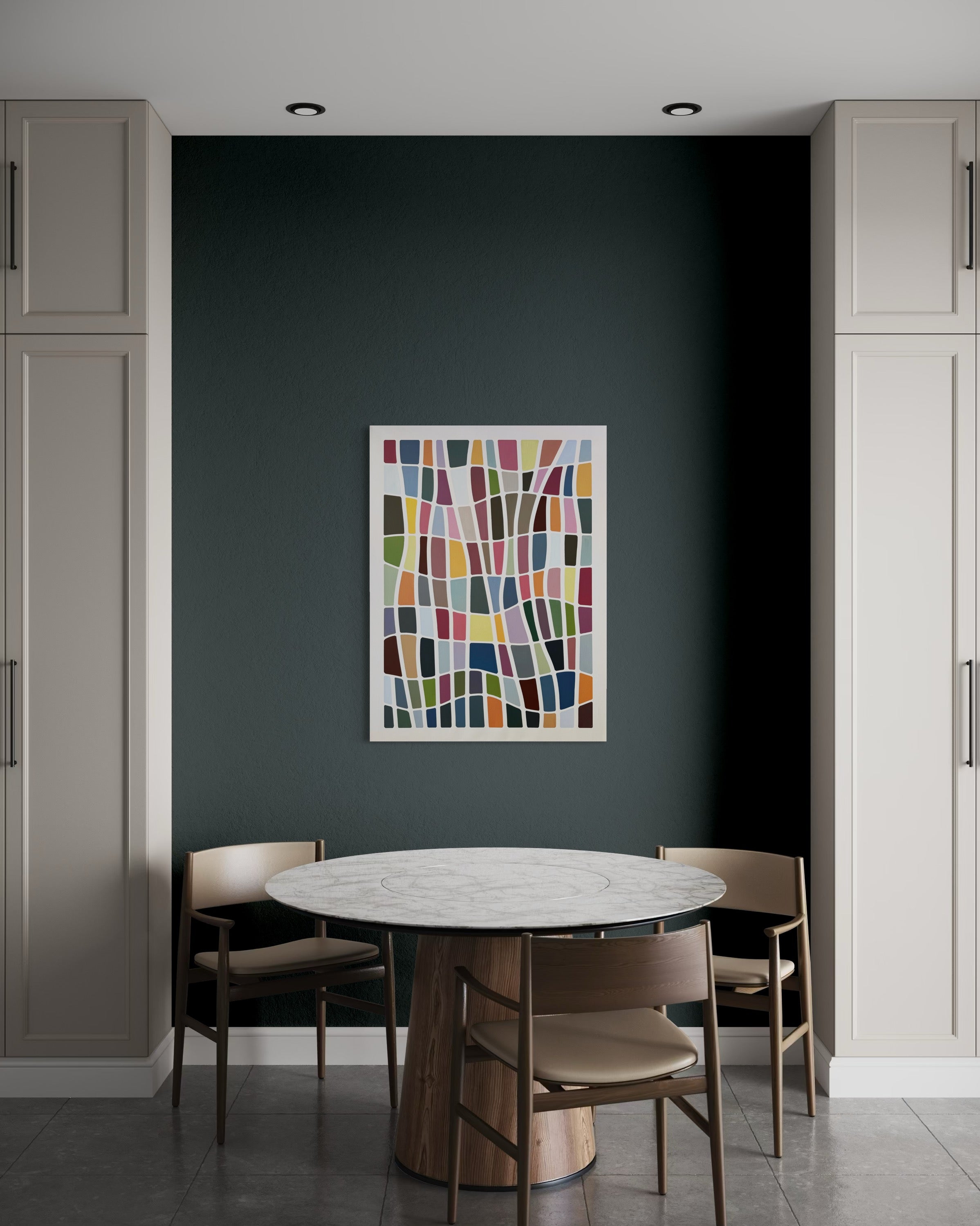 Dining room with a round table and chairs against a dark wall with colorful abstract art.