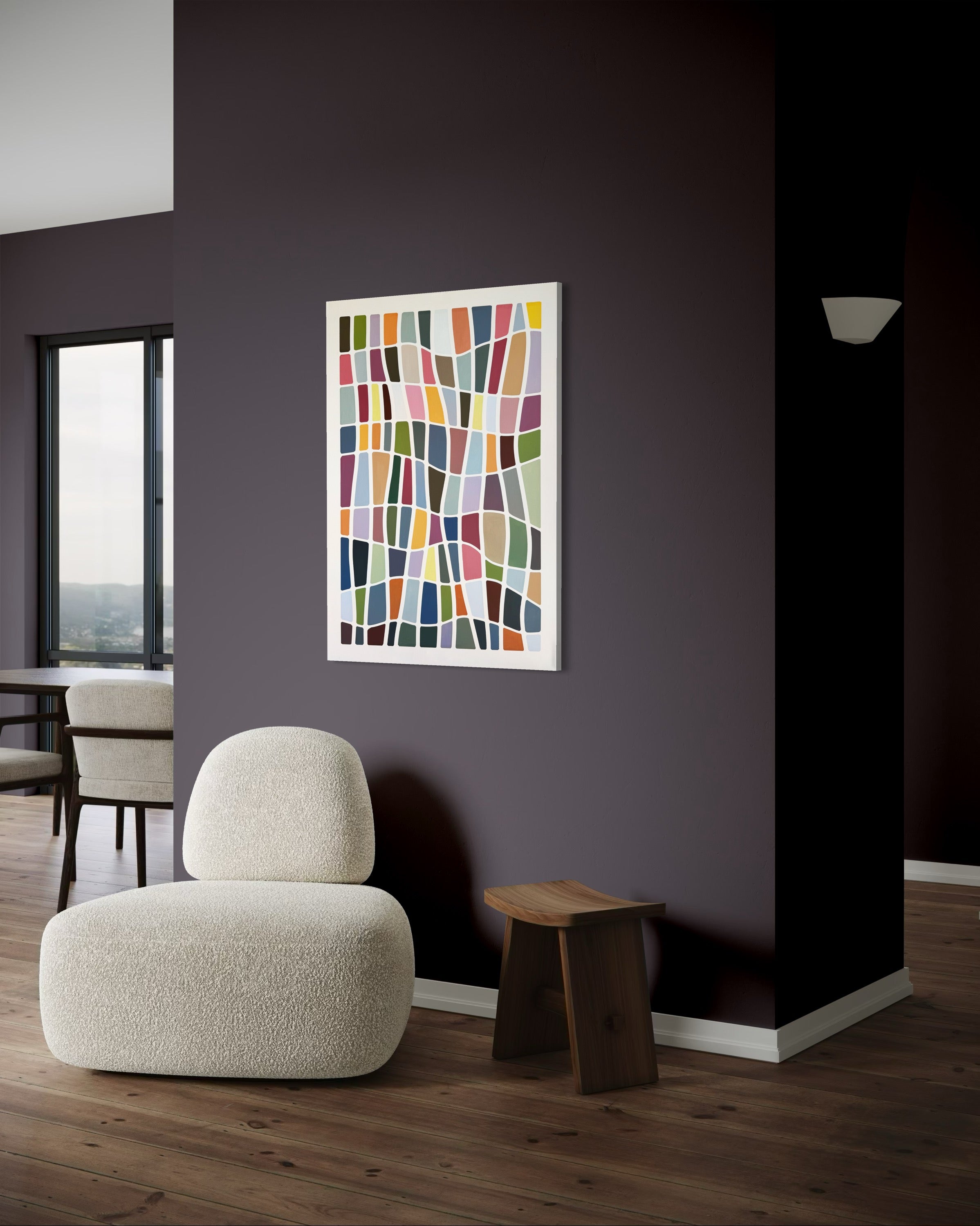 Modern interior with a colorful abstract painting on a dark wall, a white armchair, and a wooden side table.