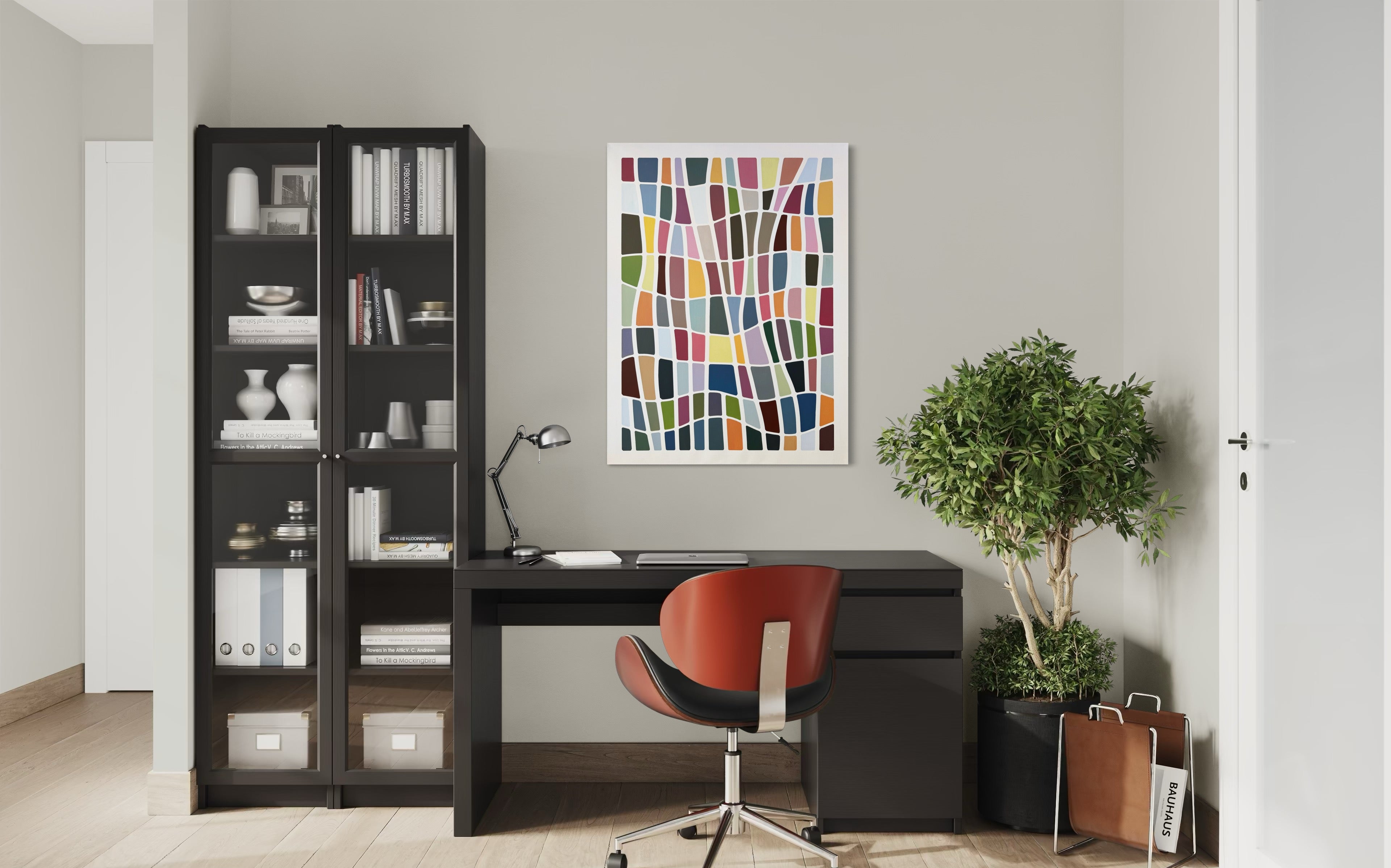 Modern office setup with a desk, bookshelf, and colorful abstract art on the wall.