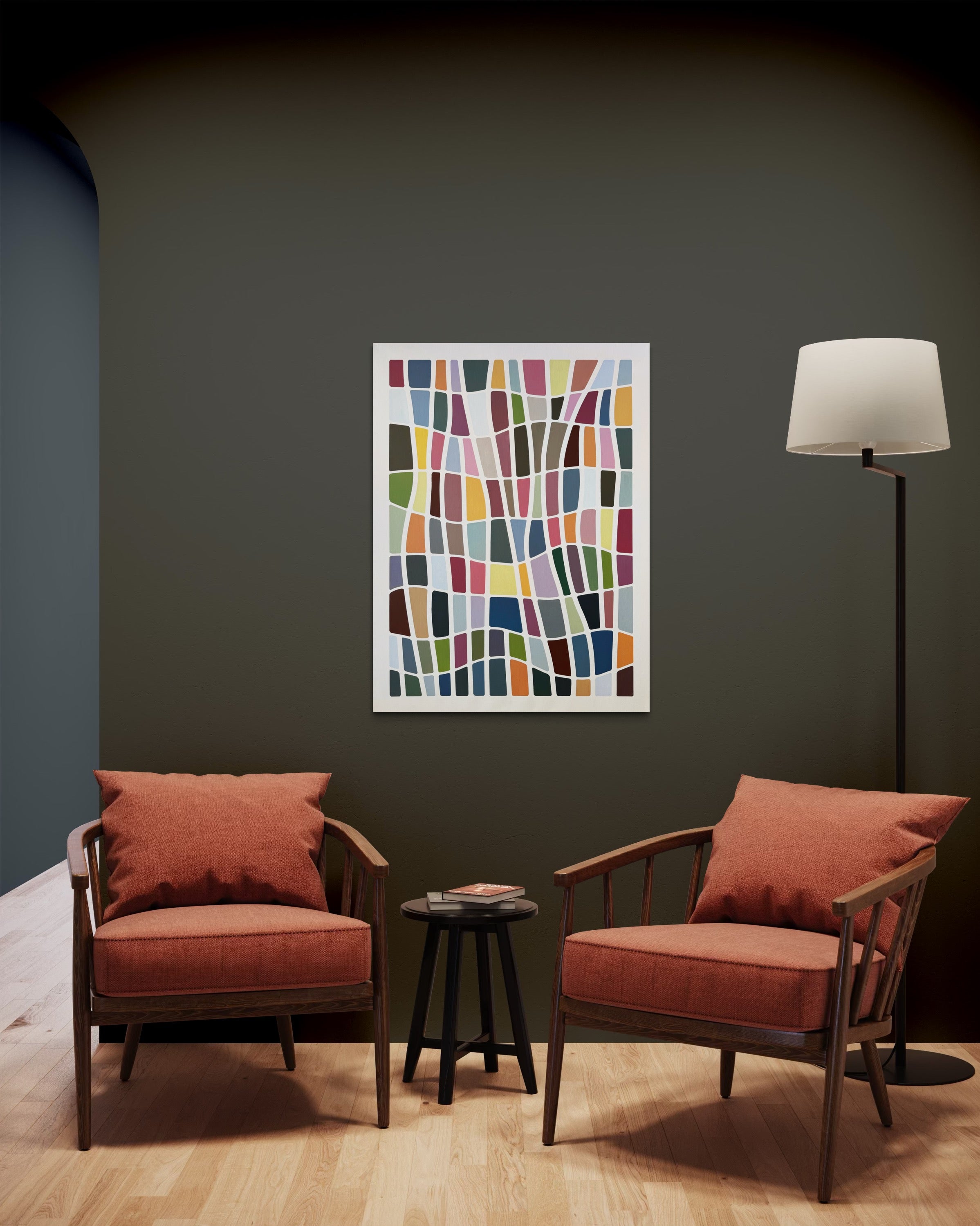 Two red chairs with cushions in a room with a colorful abstract painting on the wall.