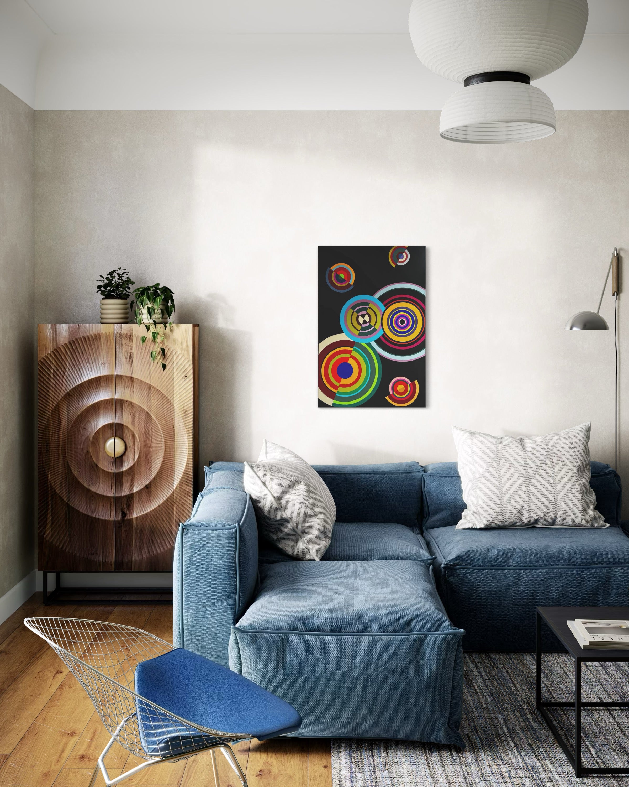 Modern living room with blue sofa, colorful abstract art, and wooden cabinet.
