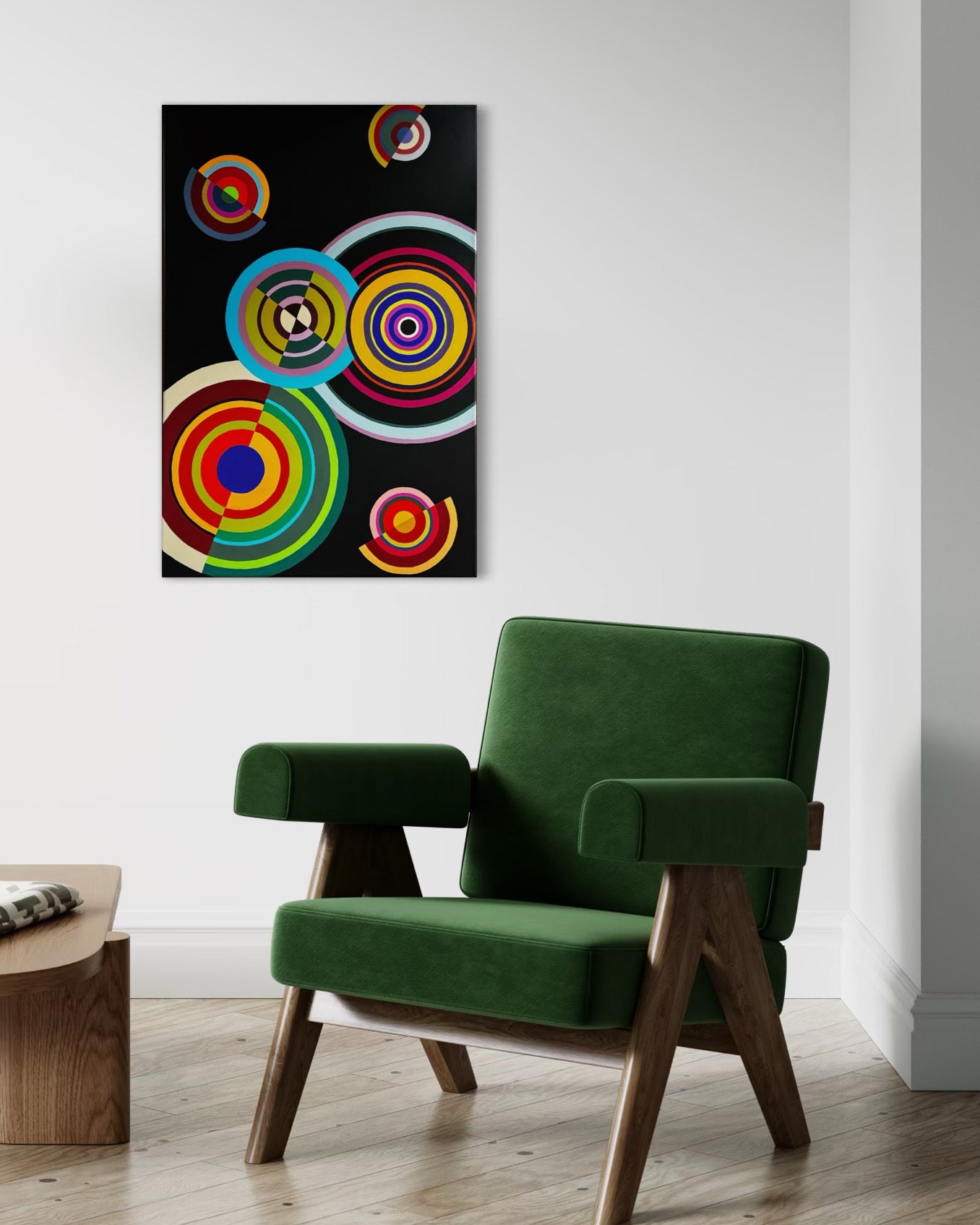 Green armchair in a room with a colorful abstract painting on the wall.