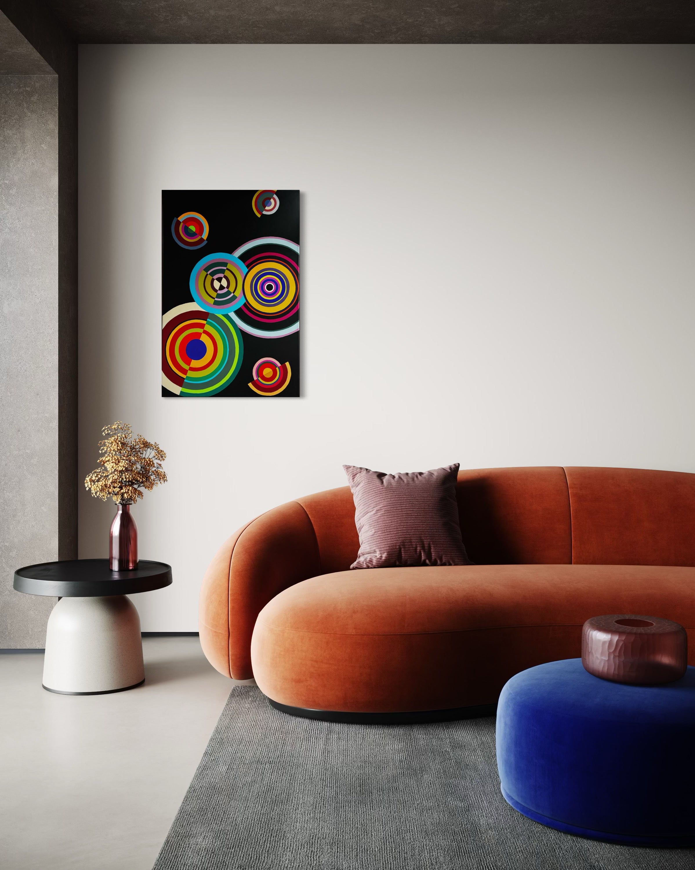 Modern living room with a colorful abstract painting on the wall, orange sofa, and blue ottoman.