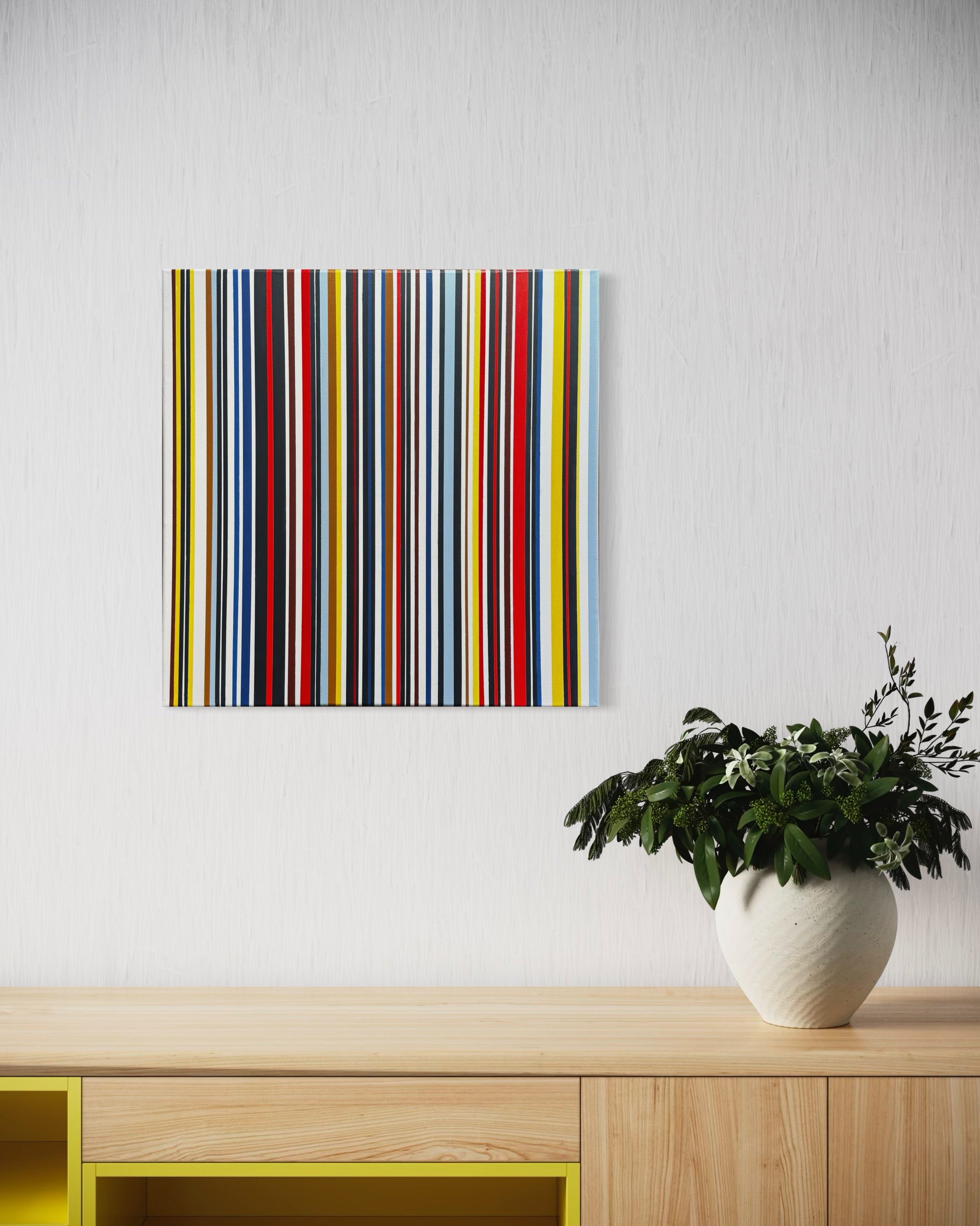 Colorful striped artwork on a white wall above a wooden shelf with a plant.