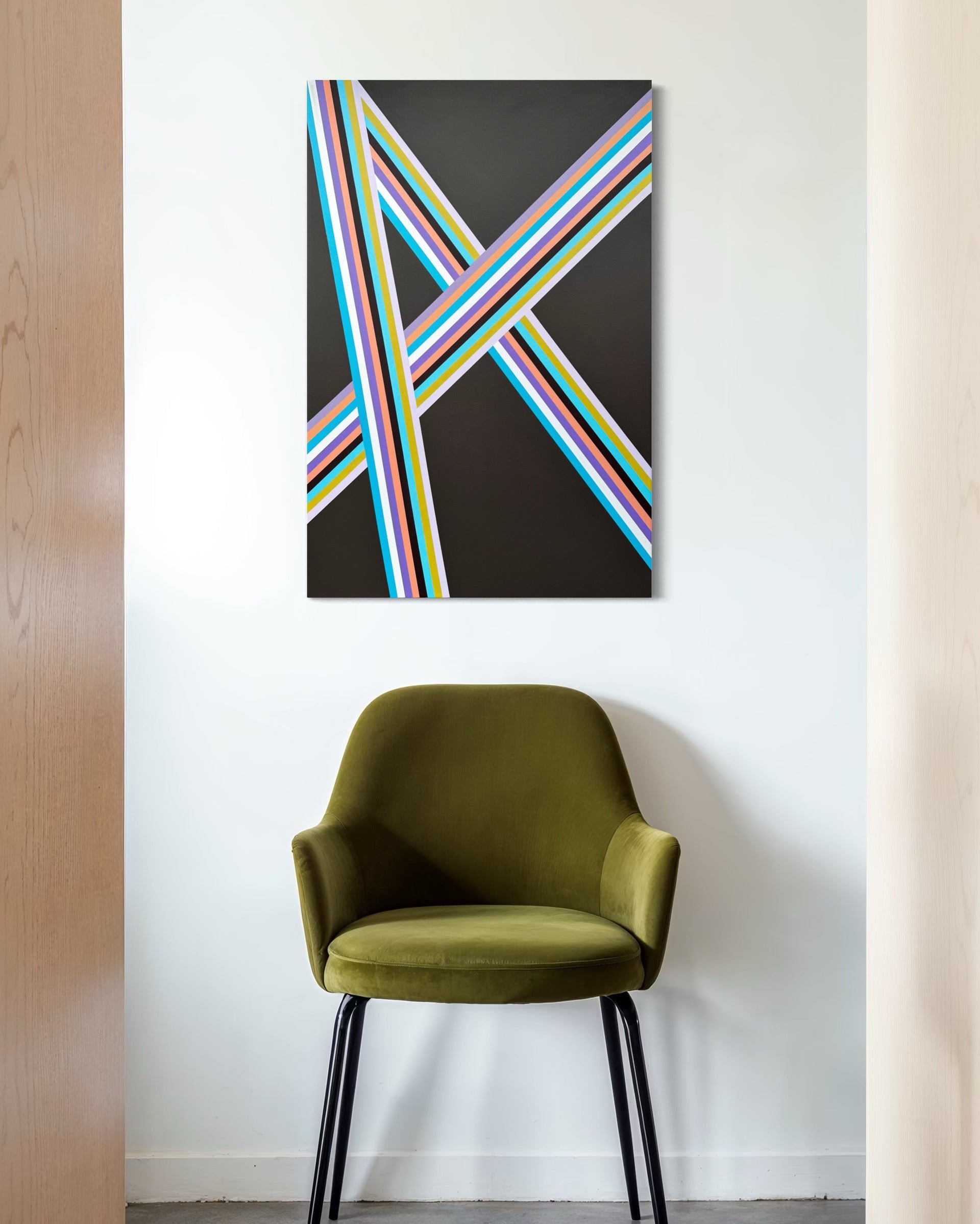 Abstract art piece with colorful stripes on a black background above a green chair.