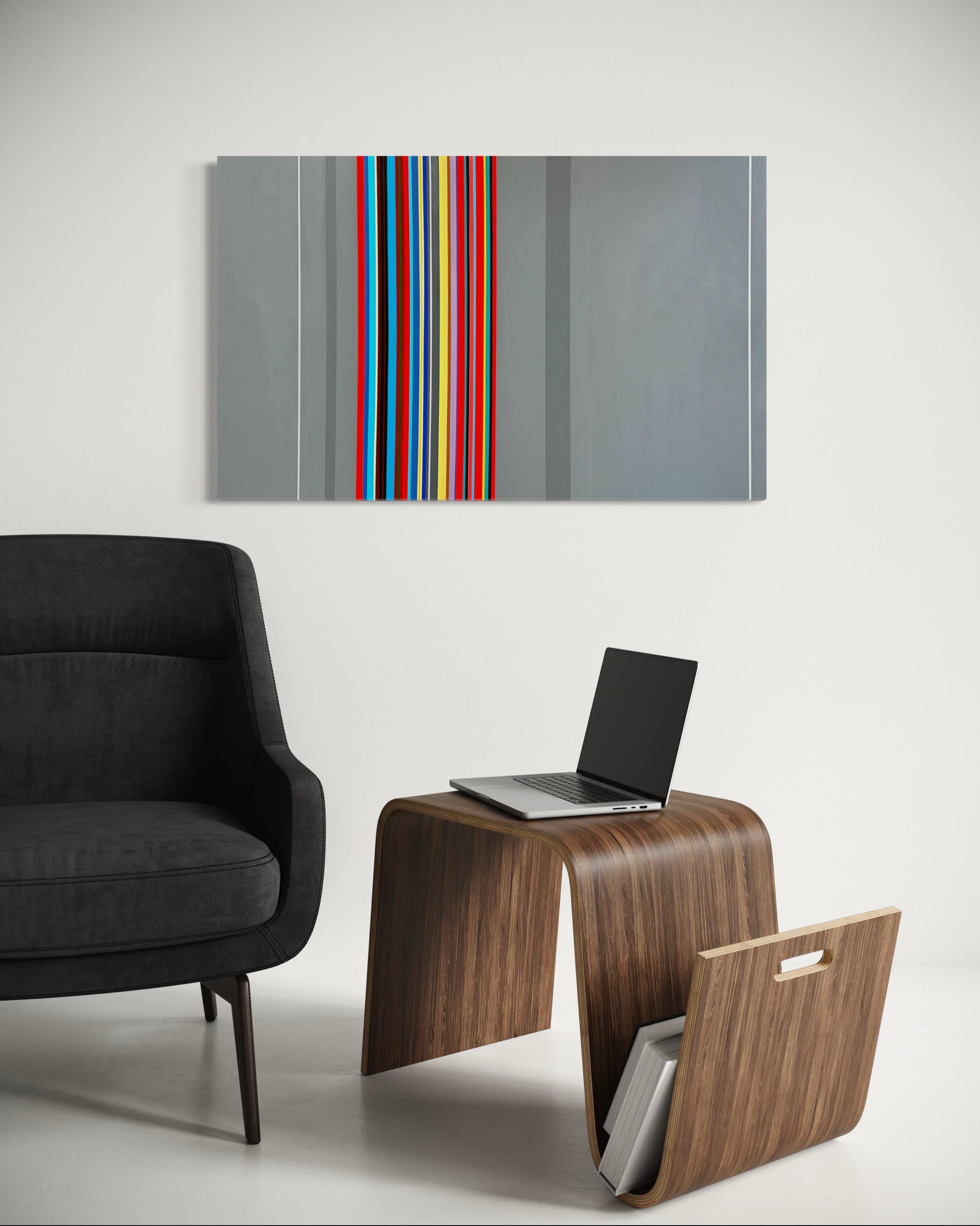 Modern living room with a black sofa, wooden side table with laptop, and abstract art on the wall.