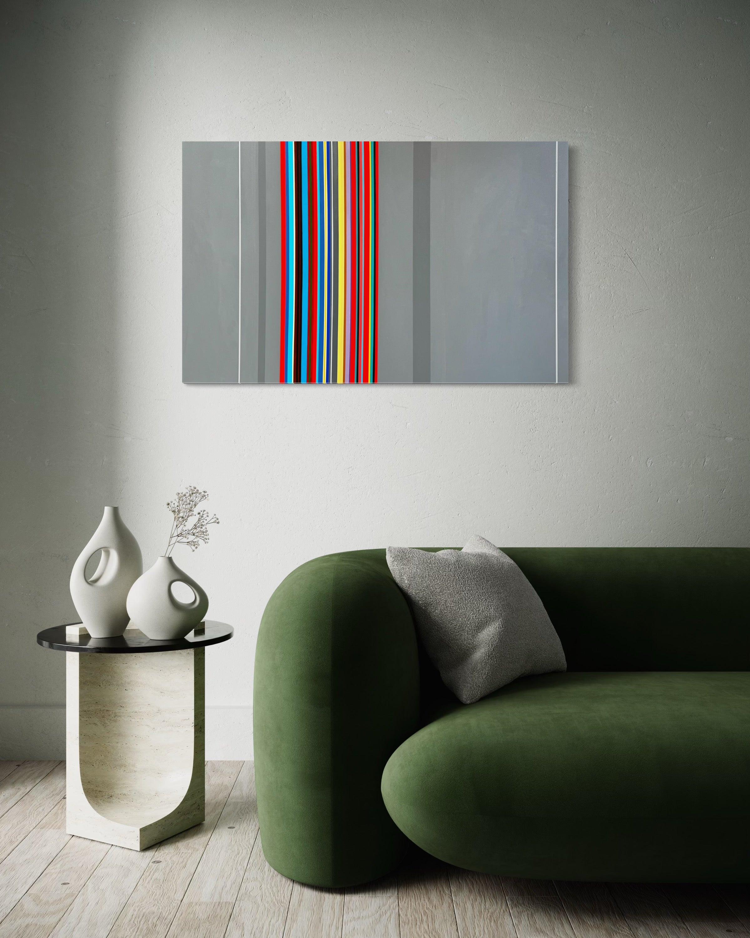 Modern living room with a green sofa, side table, and abstract wall art.