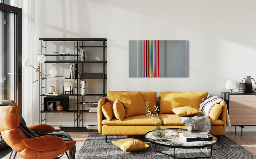 Modern living room with a yellow sofa, orange armchair, and colorful abstract painting.