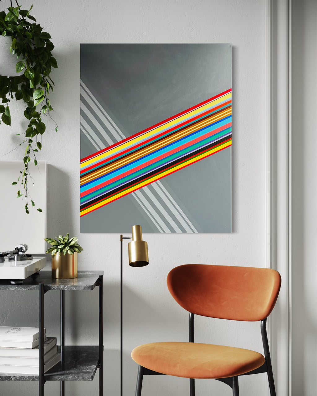 Modern interior with a colorful abstract painting on the wall, a brown chair, and a plant.