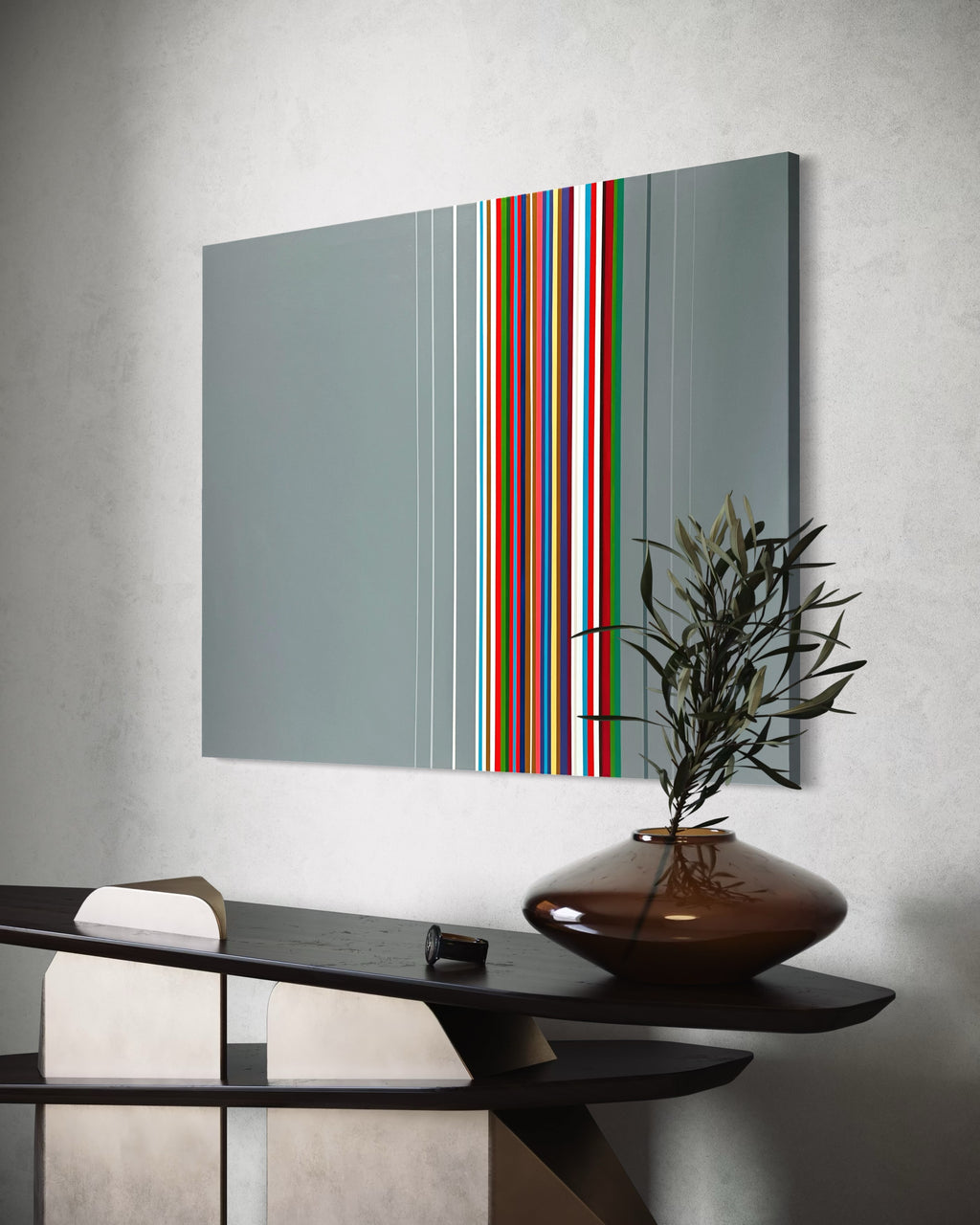 Modern interior design with a abstract wall art piece and a vase on a console table.