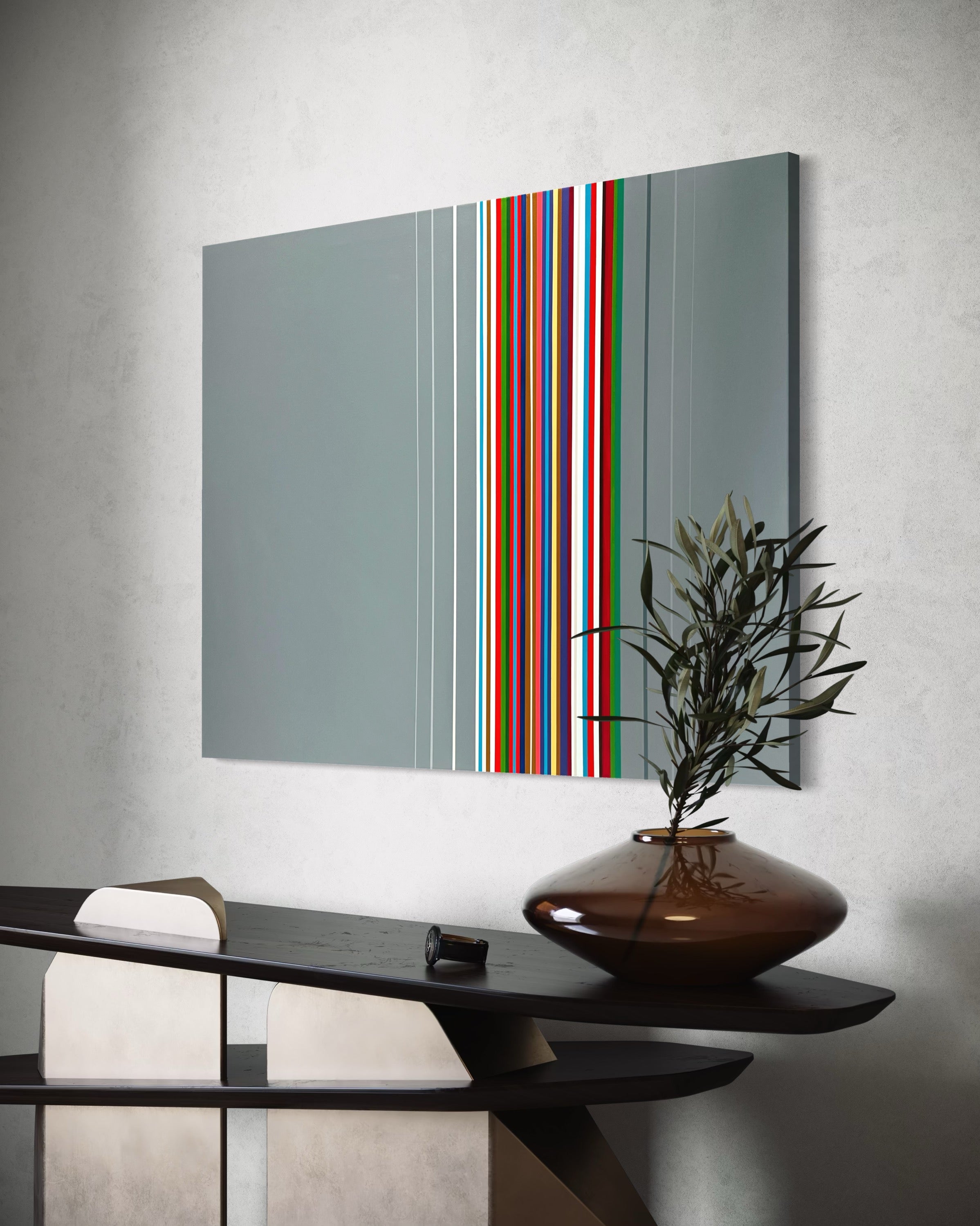 Modern interior design with a abstract wall art piece and a vase on a console table.