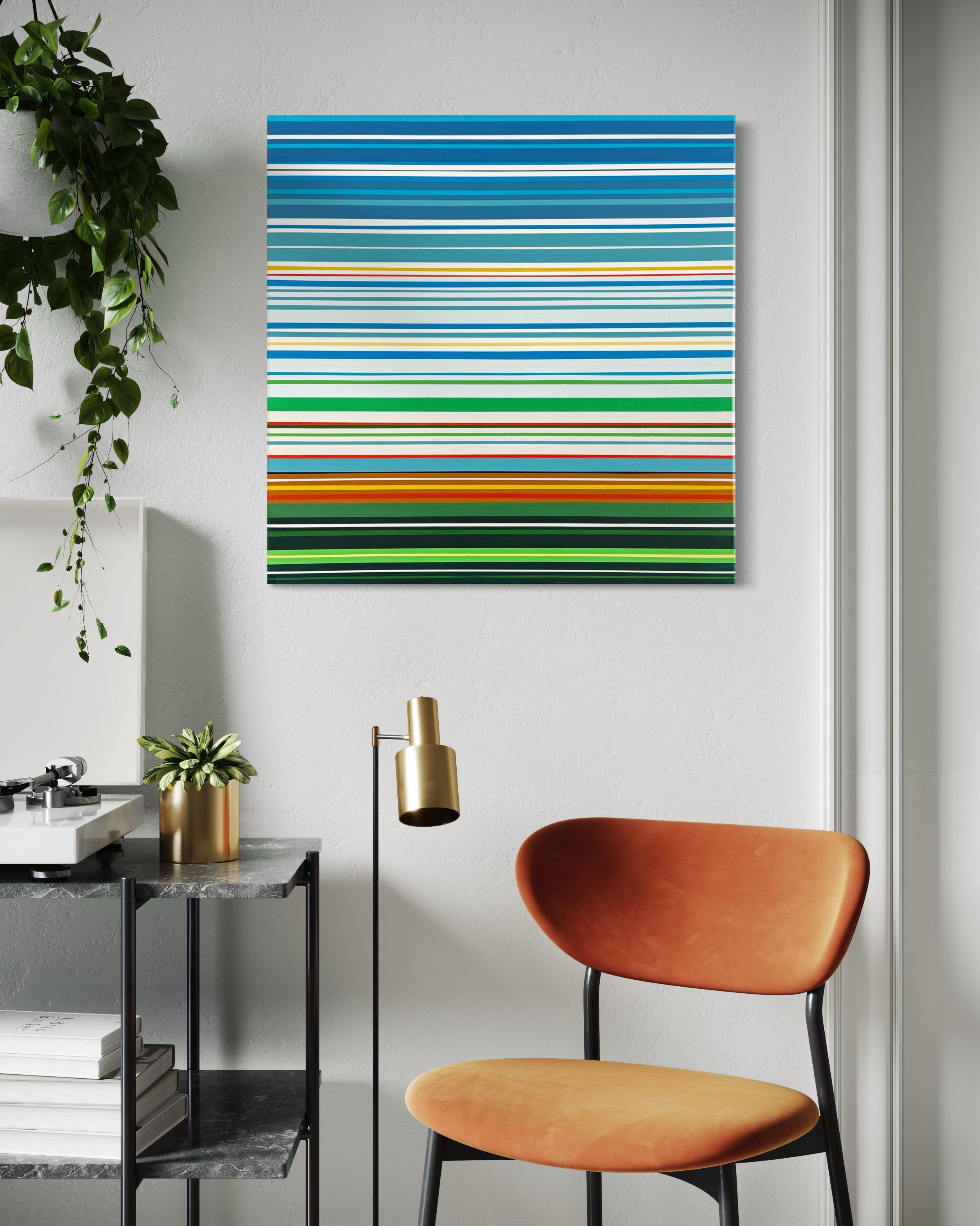 Modern interior with a colorful striped painting on the wall, orange chair, and plant.