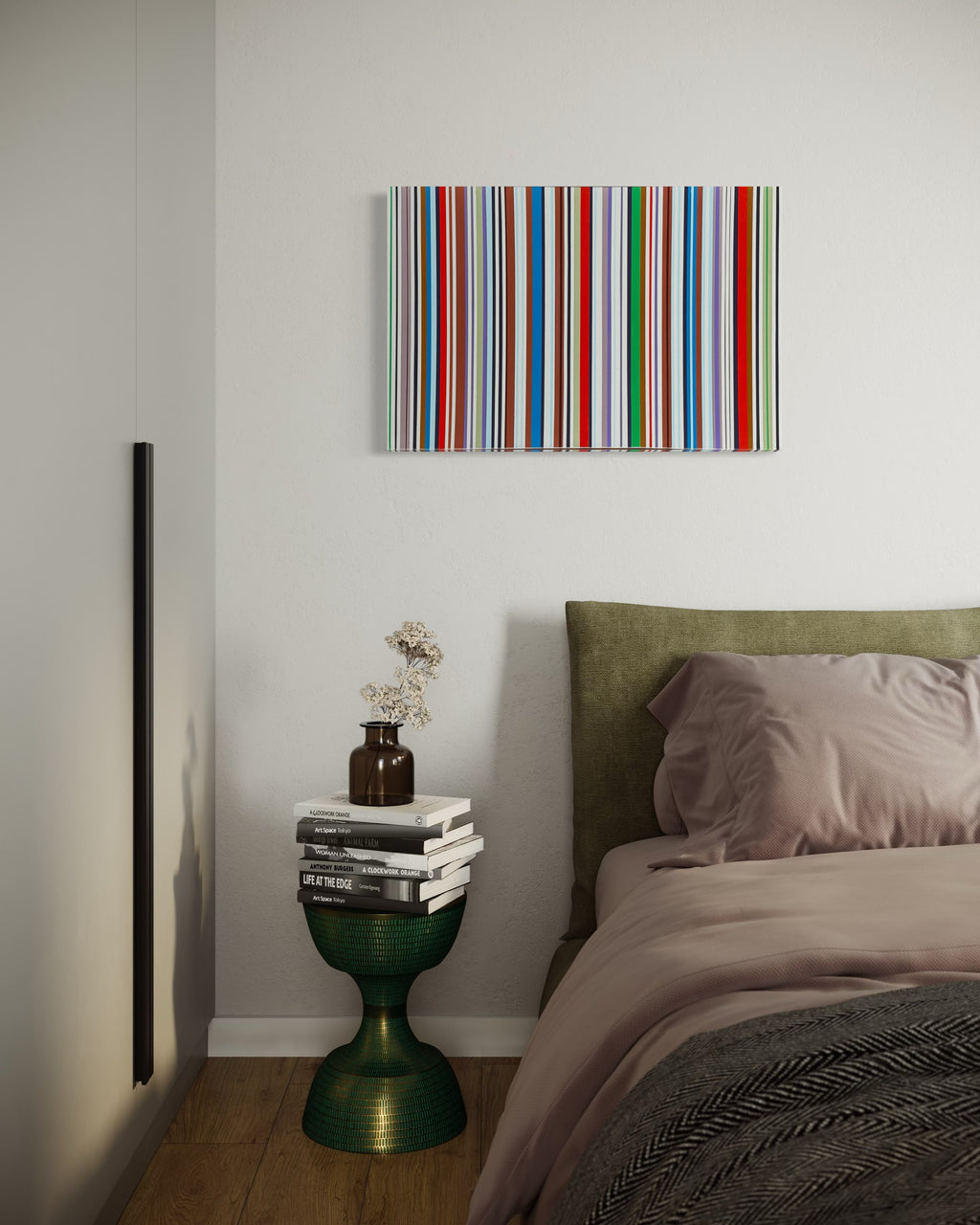 Bedroom with a colorful striped painting on the wall, a bed with green headboard, and a small table with books and a vase.