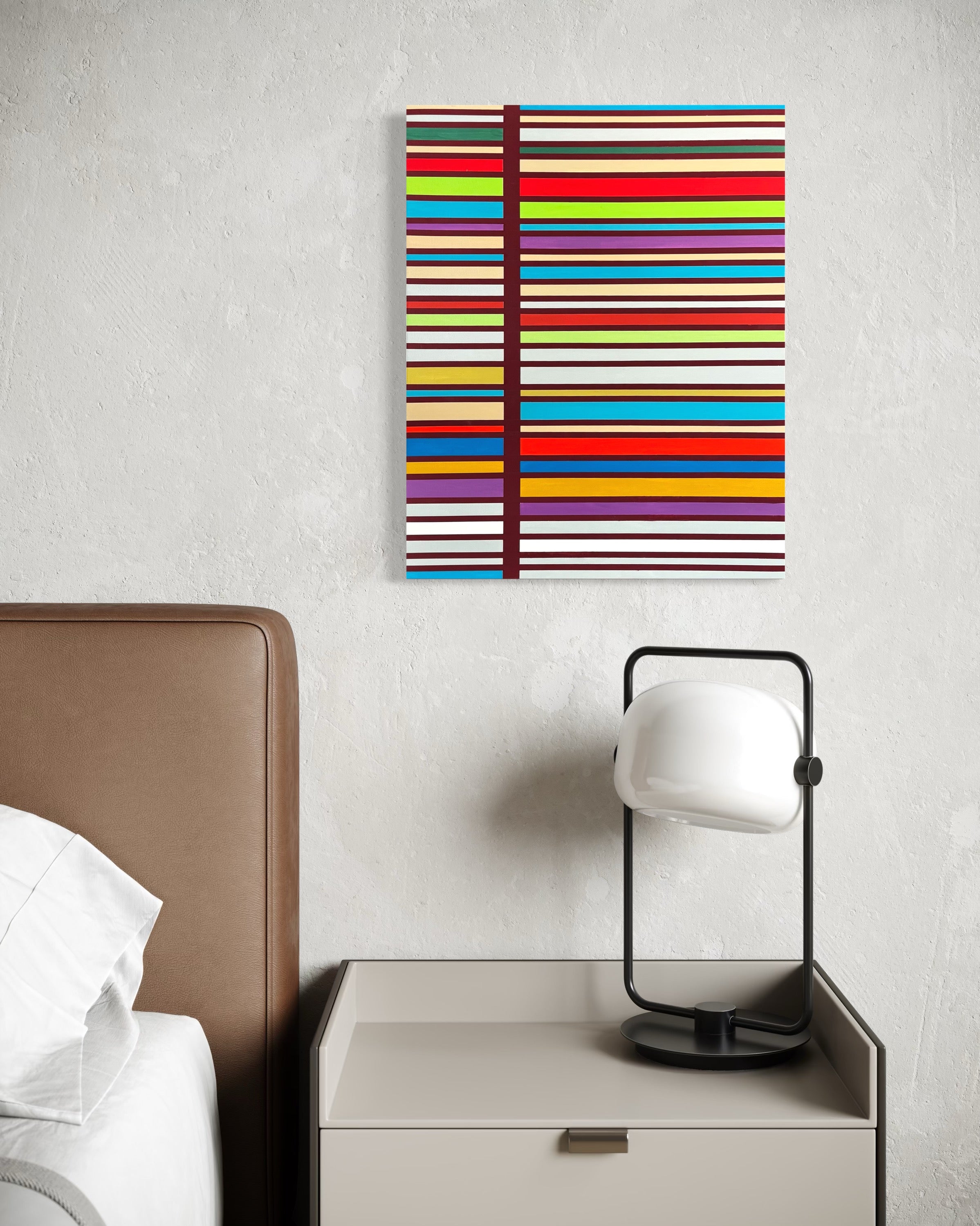Colorful striped painting on a wall above a nightstand with a lamp.