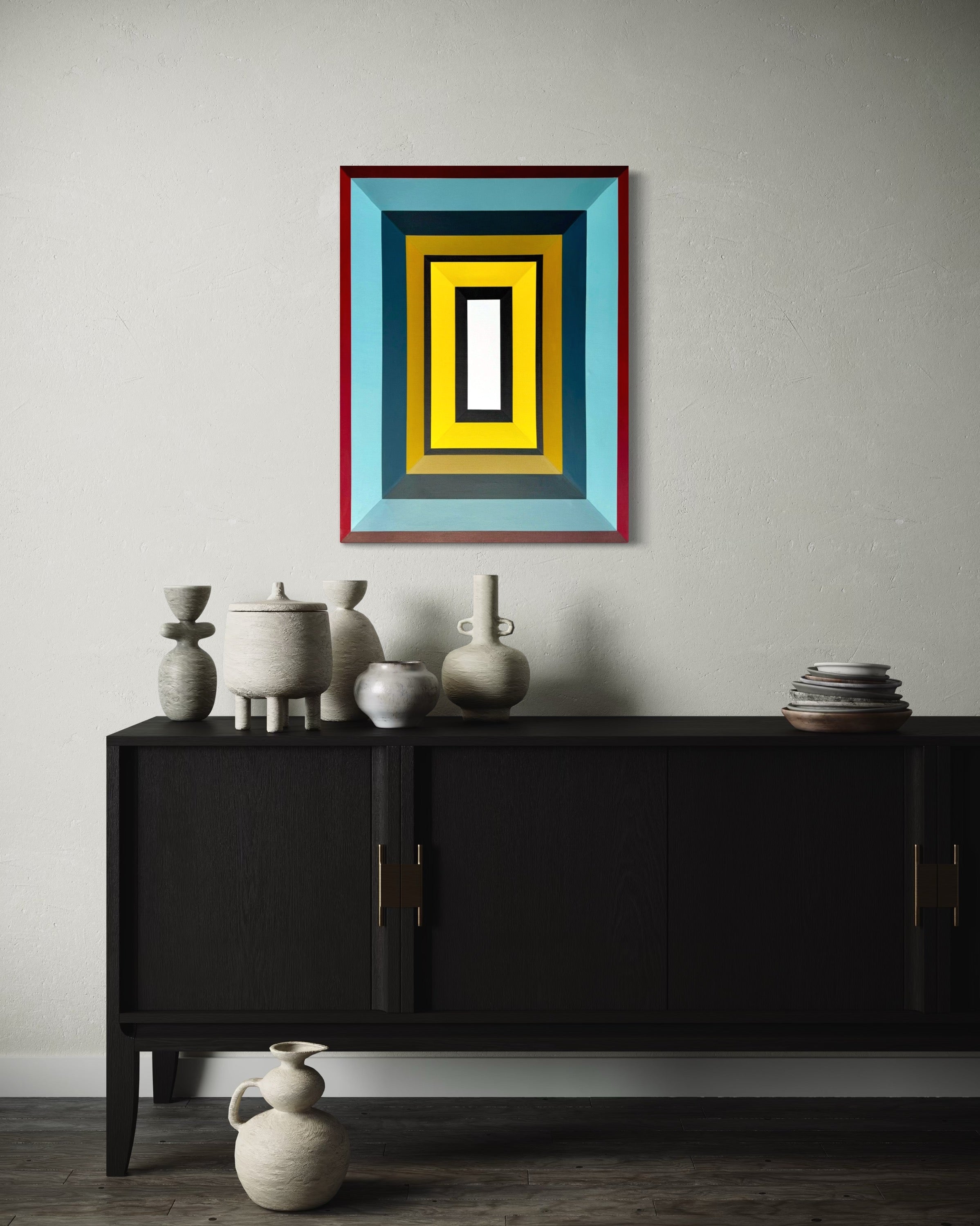 Framed abstract art piece on a wall above a black cabinet with decorative vases.