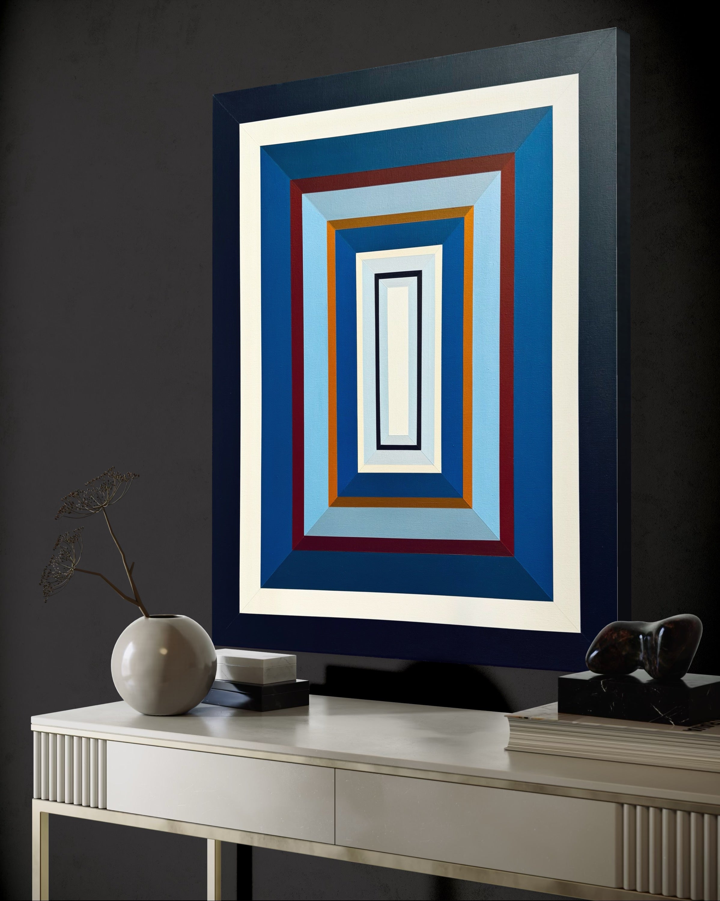 A perspective view of the "Denim-III" painting, showing how its vibrant blue layers pop against a dramatic dark charcoal wall in a contemporary living room.