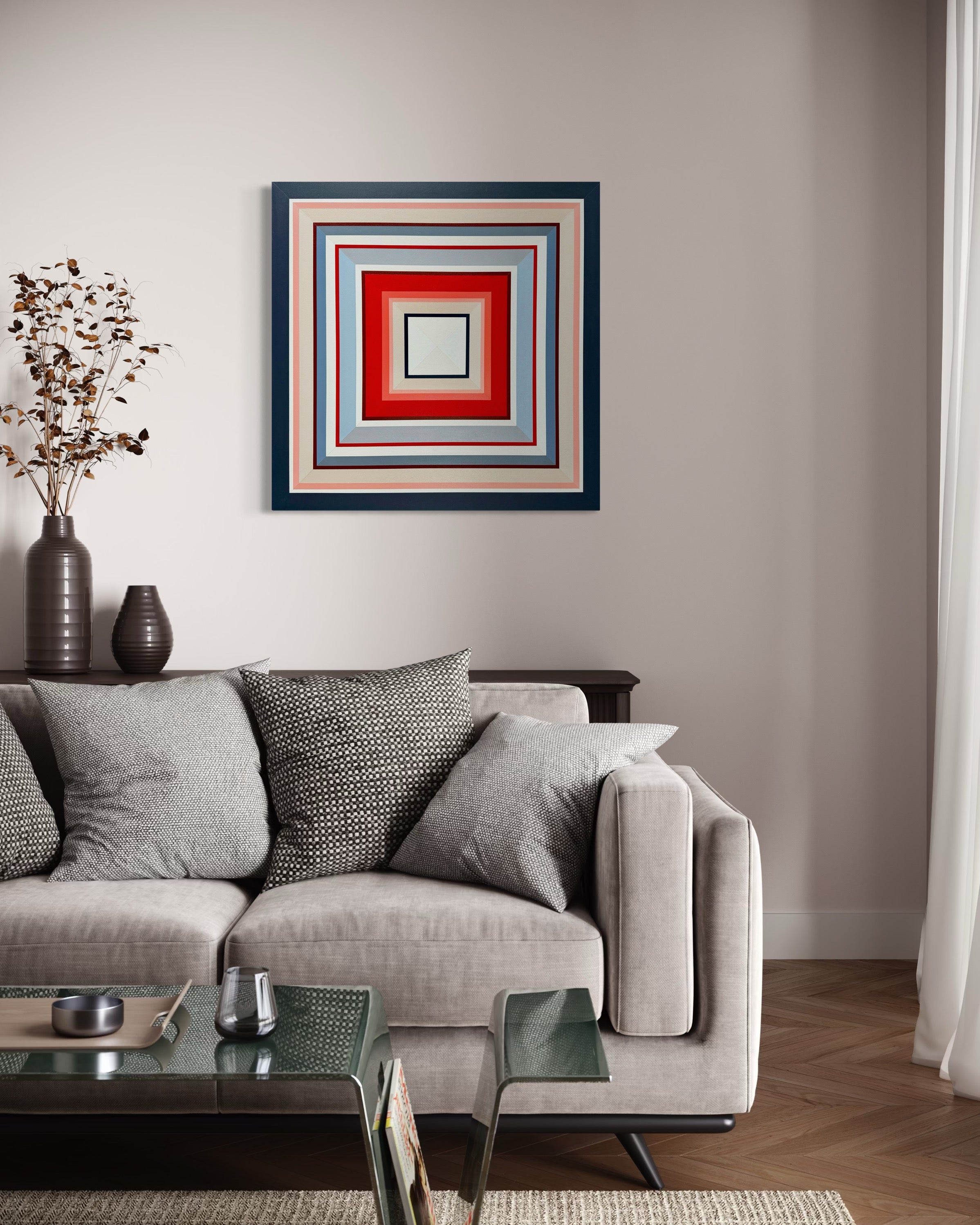 The coral and blue hues of the "In Other Words" painting provide a vibrant pop of color on a neutral wall above a comfortable light grey sofa.