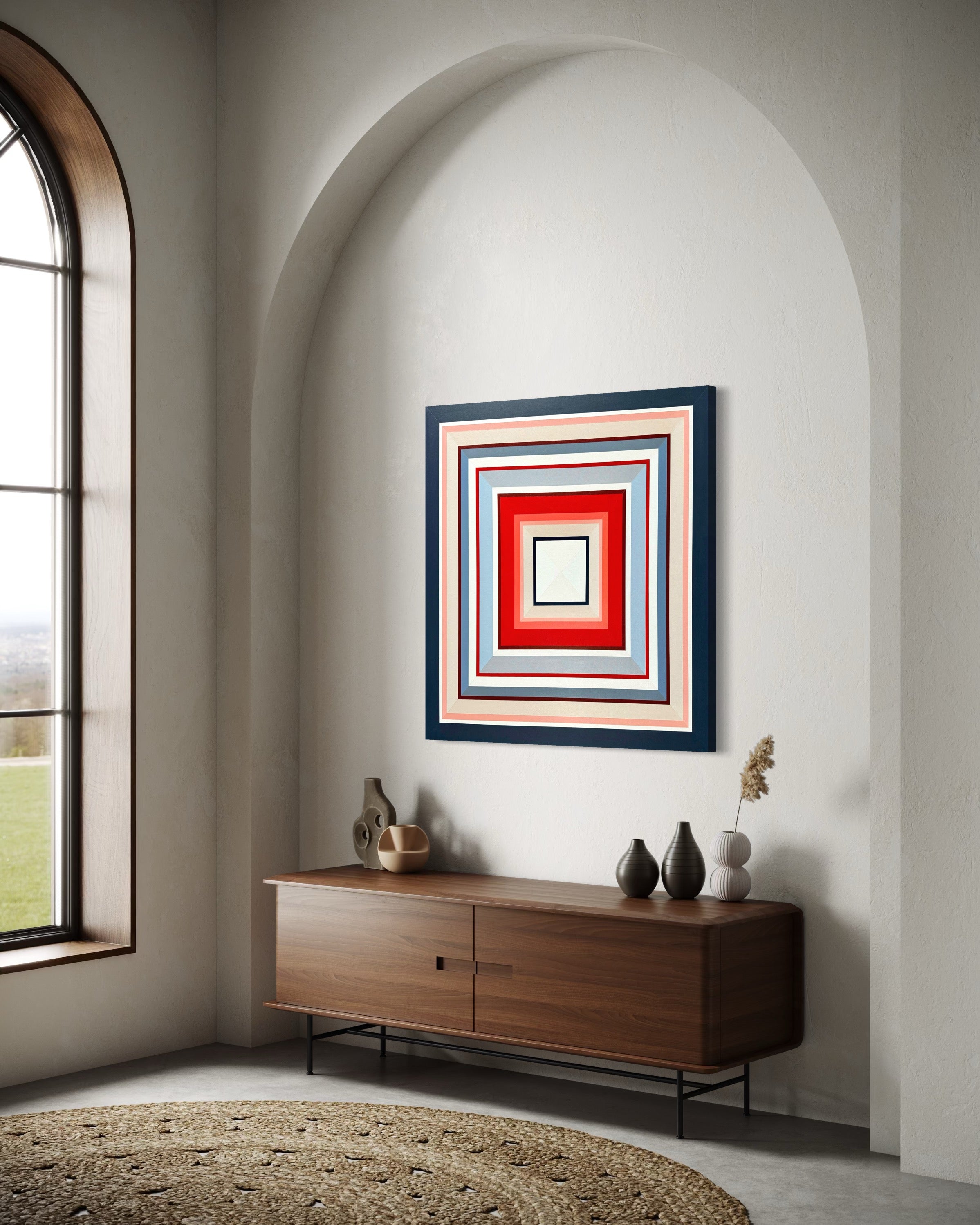 The "In Other Words" square canvas hanging in a minimalist hallway with a graceful archway, positioned above a sleek wooden media console.