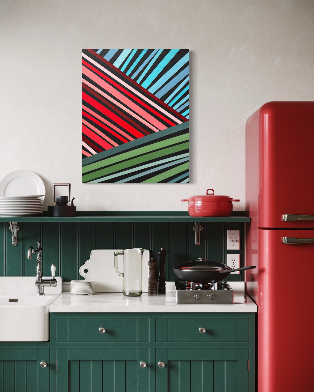 Modern kitchen with green cabinets, red refrigerator, and abstract art on the wall.
