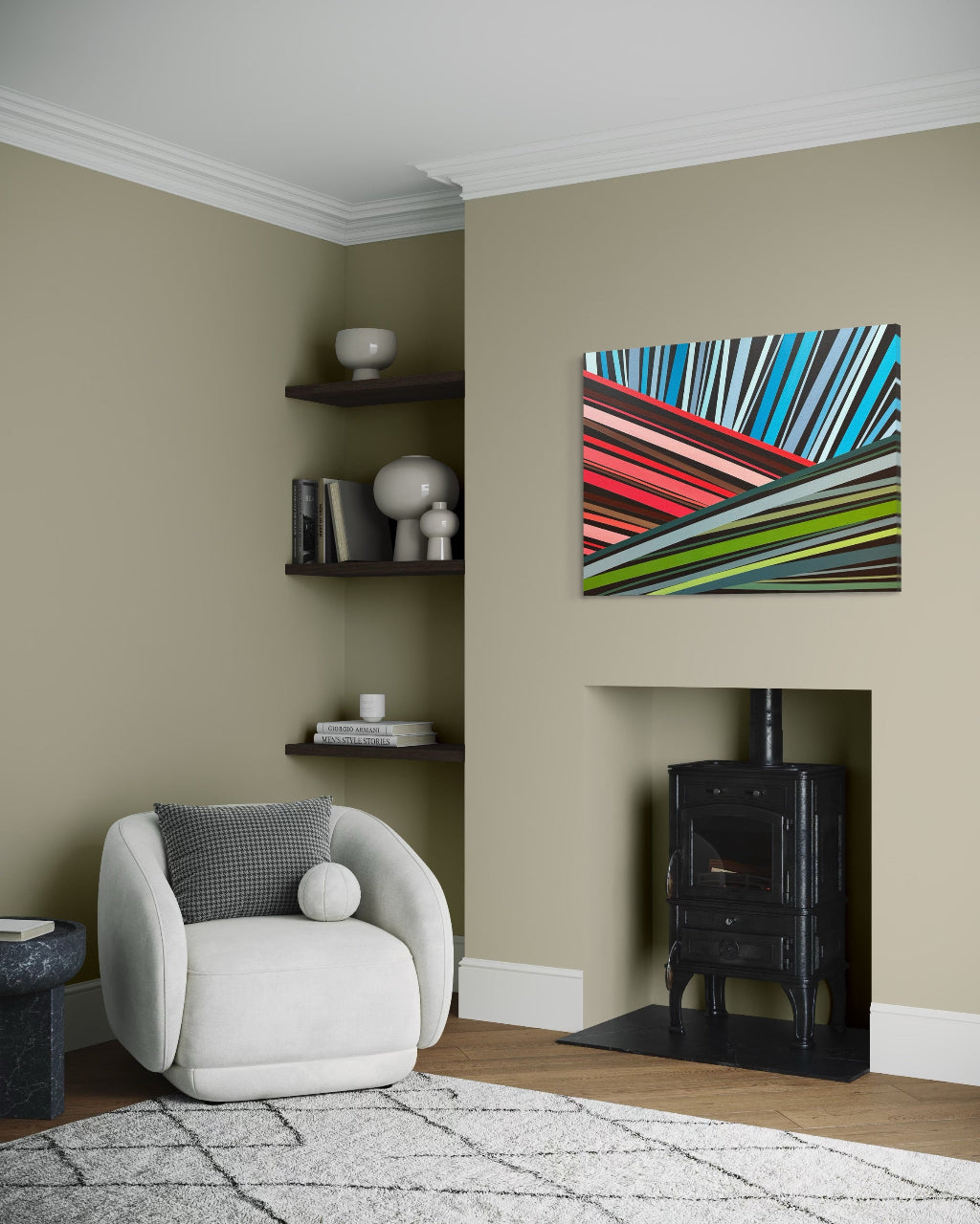 Living room with a modern armchair, shelves, and abstract artwork on the wall.