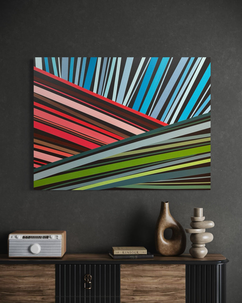 Colorful abstract painting on a dark wall with a wooden console table below.