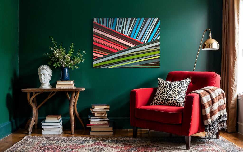 Living room with a red armchair, abstract painting, and decorative items against a green wall.