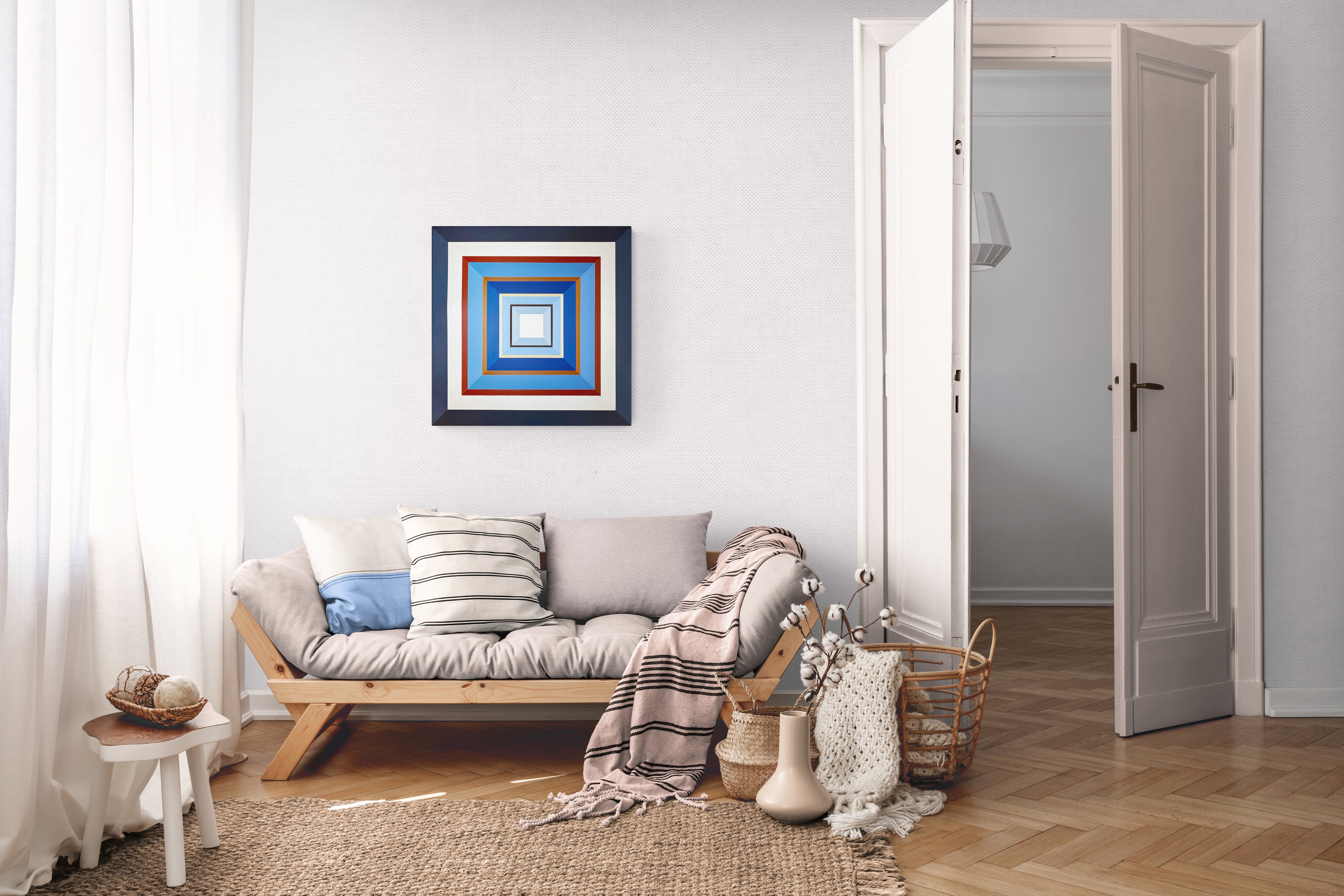 The "Denim" painting serving as a calming focal point on a large, light-colored wall in a peaceful and modern living room, showing its scale in the space.